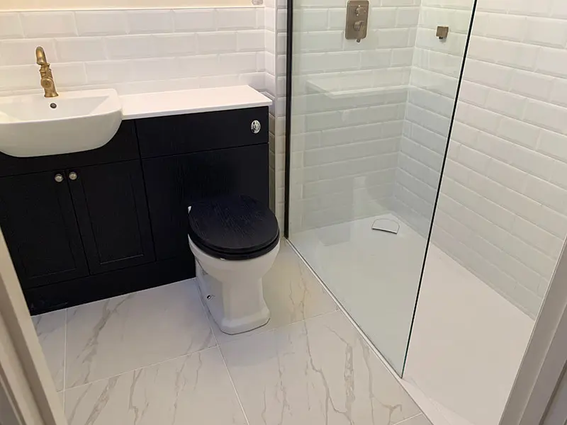 Modern black and white tiled ensuite shower room