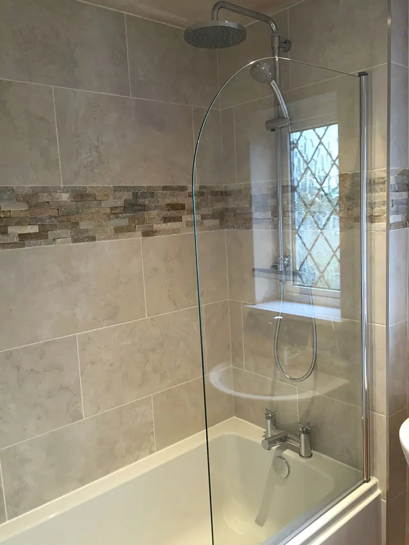 Mixture of tiles in bath and shower