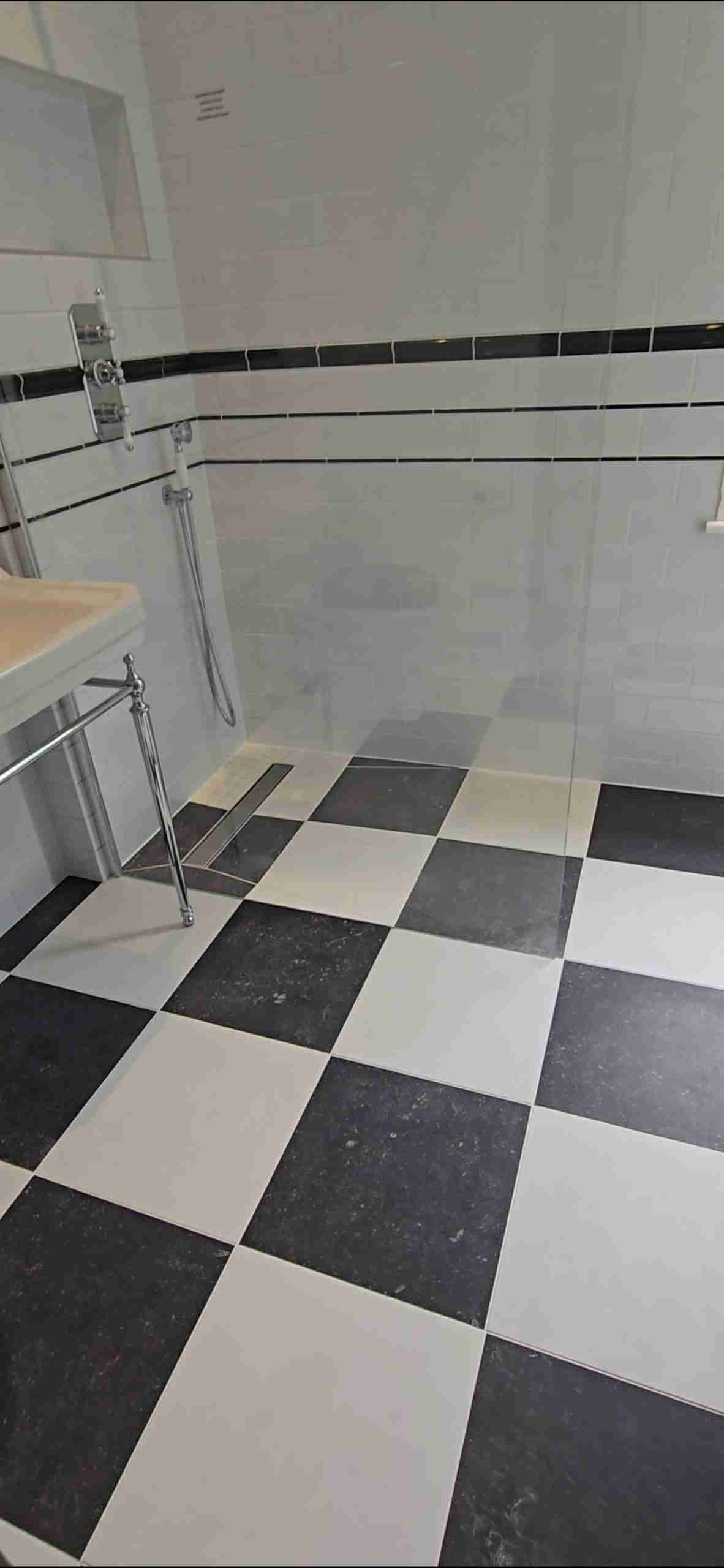 Family bathroom with walk-in shower, black and white theme.